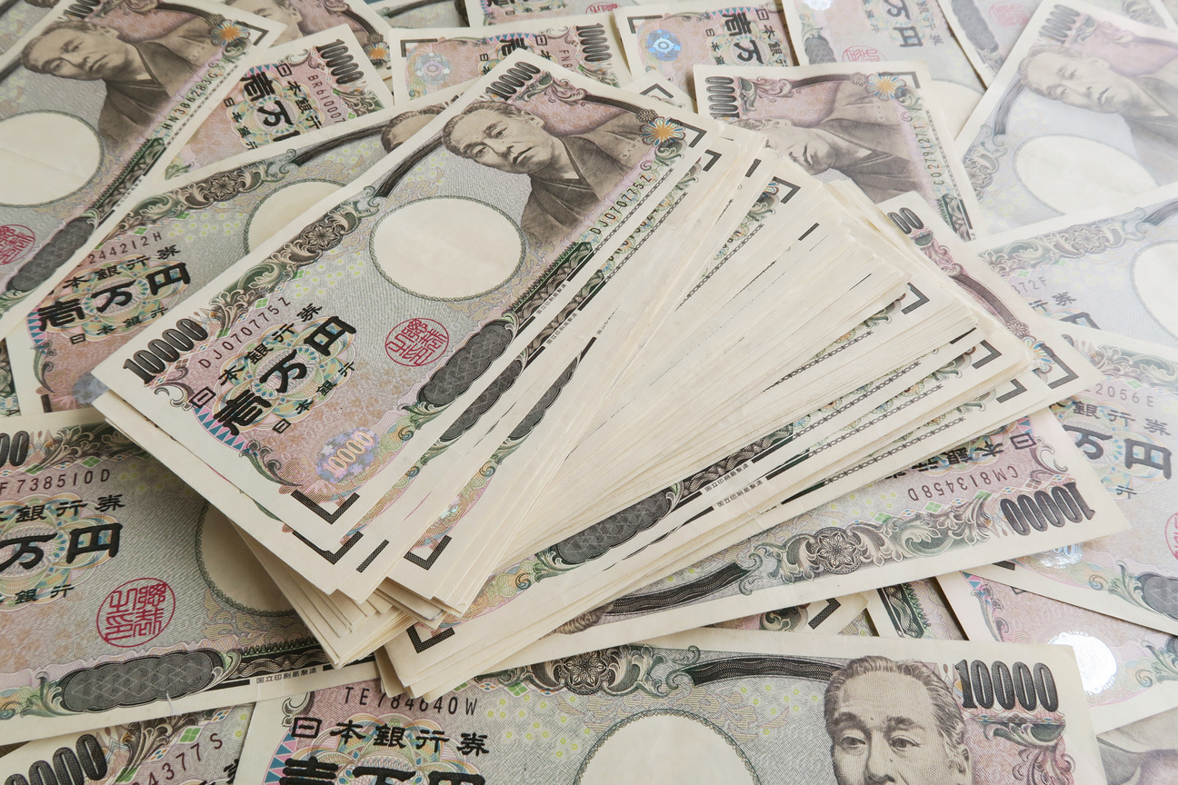 10,000 yen bills in Japanese yen spread out on the front